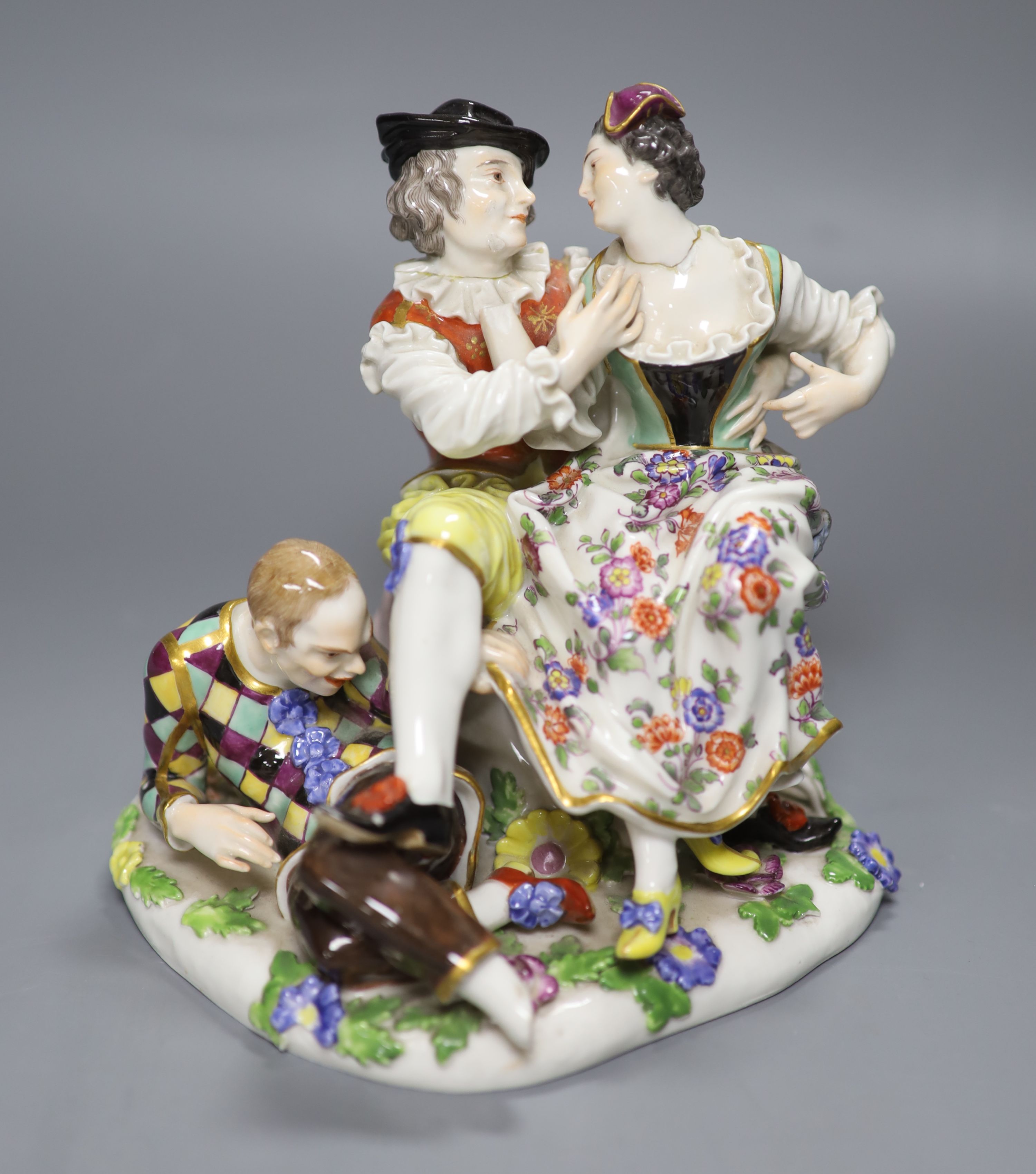 A Meissen porcelain group, The Indiscreet Harlequin, 19th century, height 16cm (a.f.)